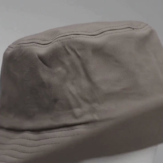 Stone Grey Bucket Hat worn by model, luxury commercial video
