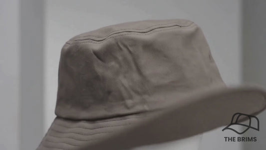 Stone Grey Bucket Hat worn by model, luxury commercial video
